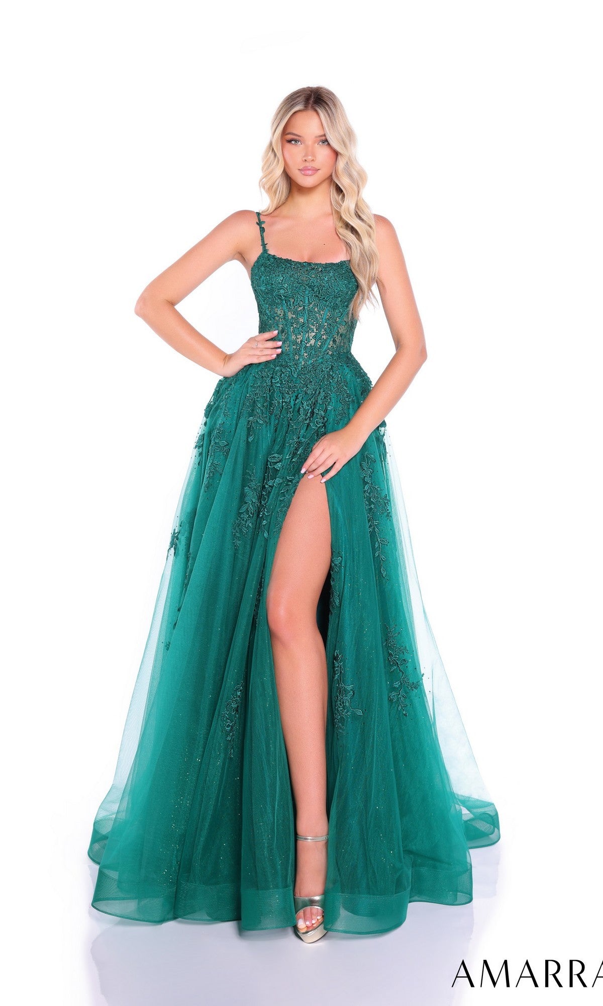 A woman poses in the emerald Embroidered-Bodice Long Prom Dress Amarra 89525, a sleeveless floor-length gown featuring a sheer overlay, sequin details, an embroidered bodice, and a high side slit.